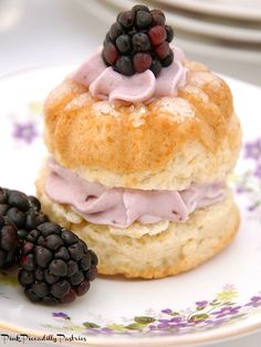 a close up of a pastry on a plate with berries