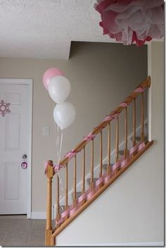 some balloons are hanging from the banister