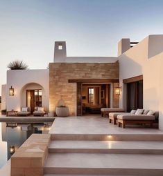 an outdoor living area with steps leading to the pool