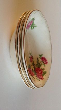 three plates are stacked on top of each other in the shape of a flowered oval