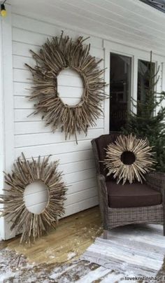 two sunburst wreaths on the side of a white house next to a chair