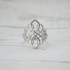 Large  925 Sterling Silver Celtic Swirl Ring The ring is made out of solid 925 sterling silver and features a gorgeous Celtic swirl design.  Silver has a feminine energy; it is related to the moon and the ebb and flow of the tides - it is fluid, emotional, sensitive and mysterious. It is soothing, calming and purifying. Silver restores equilibrium and stability to both feminine power and spiritual energy. It protects itself from outside negativity, reflecting the energy back to where it began. T Celtic Knot Ring Mens, Celtic Rings Women, Silver Celtic Rings, Silver Infinity Ring, Endless Knot, Ornate Ring, Unique Silver Rings, Celtic Ring, Love Knot Ring