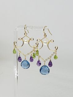 Lovely topaz quartz, natural peridot and genuine amethyst briolette chandelier drop dangle earrings, briolettes measure 10,6 and 5.5 mm and are hanging from a delicate chain, embellished with a natural 5.5 mm white akoya pearl at the center. Custom or similar piece can be made.  Earring closures upgrade available at additional cost (fleur de lis leverback, 4mm ball posts in same metal or 14k solid gold) MEASUREMENTS  Length: 2.10" including ear-wire Choose from: 14k Yellow Gold Filled 14k Rose G Drop Bead Earrings, Diy Pearl Earrings, Chandelier Earrings Diy, Packaging Earrings, Rose Gold Chandelier, Amethyst Earrings Gold, Silver Packaging, Gold Chandelier Earrings, Unusual Earrings