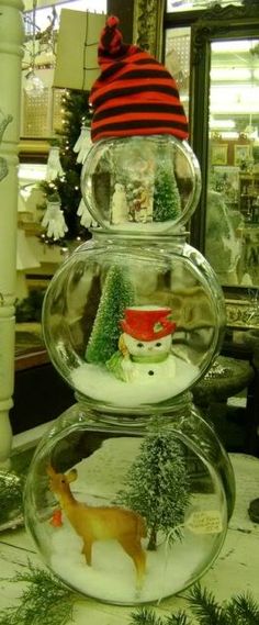 there are snow globes with christmas decorations in them