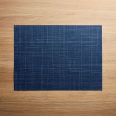 a blue place mat sitting on top of a wooden table next to a knife and fork