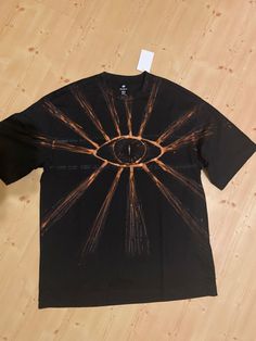 a black t - shirt with an image of the eye of providence printed on it