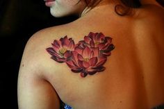 the back of a woman's shoulder with pink flowers on her left arm and chest