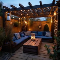 an outdoor seating area is lit up with string lights