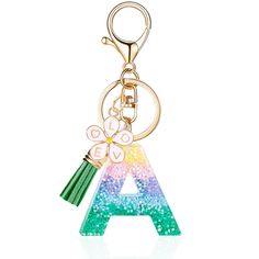 a keychain with a letter and a butterfly on it's side, in the shape of a rainbow