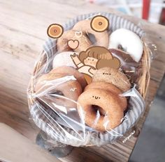 a basket filled with donuts sitting on top of a wooden table