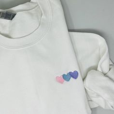 Embroidered White Sweatshirt For Gift, White Crew Neck Sweatshirt With Heart Graphic, Custom Embroidered Cotton Sweater As Gift, Gift Cotton Sweater With Custom Embroidery, White Sweatshirt With Letter Embroidery As Gift, Custom Embroidery Cotton Sweater As Gift, Cotton Sweatshirt With Embroidered Graphics For Gift, Cotton Sweatshirt With Heart Graphic And Long Sleeves, Cotton Sweatshirt With Heart Graphic, Long Sleeve