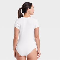 Update your separates closet with the Ribbed Bodysuit from A New Day™. This short-sleeve, pull-on tank bodysuit is designed in elegant solid hues for versatile styling, and it has a crew neckline with a plain back for a classic look. Made from a soft and stretchy cotton-blend ribbed fabric to give you a comfortable fit that moves with you, it also boasts a full-coverage bottom with metal snaps at the crotch for added convenience and confident wear. Wear it with everything from jeans or maxi skir Fitted One-piece Bodysuit For Loungewear, Fitted White Short Sleeve Bodysuit For Summer, White Fitted Short Sleeve Bodysuit For Summer, White Stretch Cotton Short Sleeve Bodysuit, White Stretch Bodysuit For Loungewear, Basic Bodysuit For Loungewear In Spring, Basic Fitted Onesie For Spring, Spring Loungewear Short Sleeve Bodysuit, Fitted White V-neck Bodysuit