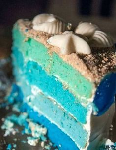 a slice of cake with blue and green frosting