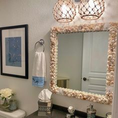 a bathroom with a sink, mirror and pictures on the wall