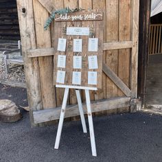 a wooden sign sitting in front of a building