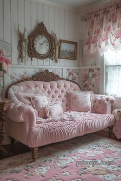 a pink couch sitting in the corner of a room next to a window with flowers on it