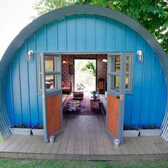 the inside of a blue building with wooden floors