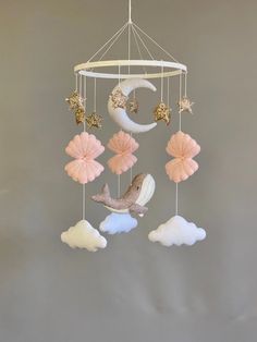 a mobile with stars, moon and clouds hanging from it