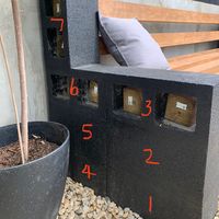 a planter filled with dirt next to a bed