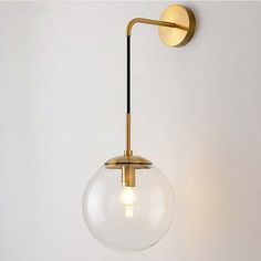 a light that is on the wall with a glass ball hanging from it's side