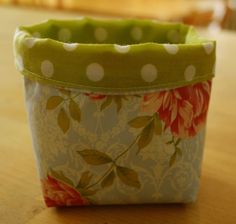 a flower pot sitting on top of a wooden table