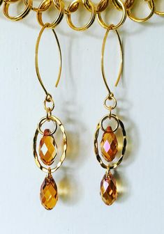 Elegant, minimalist cognac, floating faceted crystal pendant earrings. Handmade 24k gold vermeil over sterling silver findings with Swarovski Crystal Teardrop elements on horse eye ear wires. Lightweight, elegant ear candy with a pop of floating crystal magic. Love creating with Swarovski elements! ♥️  Uniquely designed by me!💎 Thanks for stopping by! 🙏🌸 Nickel-free Gold Briolette Earrings, Gold Briolette Crystal Earrings With Ear Wire, Gold Briolette Earrings Nickel Free, Modern Gold Briolette Earrings, Gold Hypoallergenic Briolette Earrings, Hypoallergenic Gold Briolette Earrings, Gold Faceted Crystal Earrings For Gift, Gold Faceted Crystal Earrings For Anniversary, Elegant Gold Faceted Crystal Earrings