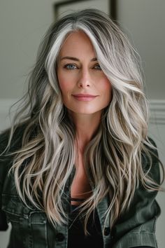 Tailor your hairstyle to enhance your piercing green eyes with long, wavy locks that showcase a smooth balayage. These hair styles for women over 50 add a touch of elegance to your everyday look. Women’s Hairstyles 50+, 55 Plus Hairstyles, Low Lights With Gray Hair, Blond Grey Balayage, Blonde To Grey Hair Transformation, Grey Long Hair Older Women, Long Hair 2024 Trends Women, Gray Hairstyles For Women Over 50, Medium Grey Hair Over 50