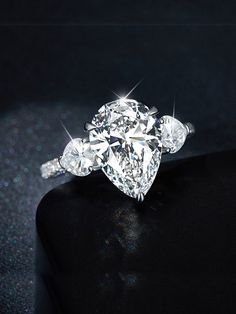 an engagement ring with three pear shaped diamonds