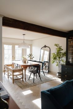 a dining room table and chairs in front of a window