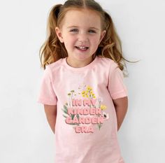 Hey, parents gearing up for the first day of school frenzy! Check out our adorable girls' t-shirt that screams "in my kindergarten era" with a splash of colorful flowers - perfect for your little fashionista. Made for comfort and style, this tee is a must-have for your child's back-to-school wardrobe. Whether it's to say hello to kindergarten or just to rock a cute look, this shirt is a winner. Crafted with care, it's ideal for creating sweet memories on that special first day. Give your girl a confidence boost with this charming piece of children's clothing. Get ready to capture those unforgettable moments in style! ♥︎ 100% airlume combed and ring-spun cotton (fiber content varies for different colors) ♥︎ Extra light fabric ♥︎ Tear-away label Hello Kindergarten, Childrens Clothing, Girl A, Confidence Boost, Sweet Memories, First Day Of School, Kids Tops, First Day, Colorful Flowers