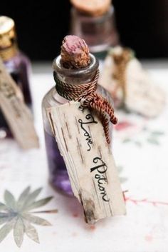 an old bottle with some writing on it sitting on a table next to other bottles