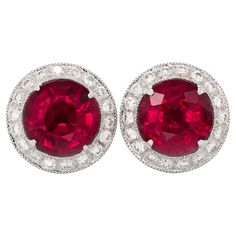 Set with perfectly matched 3.25 carats Rubellites, this pair of classic studs will add color to any outfit. Eye clean gems that have been cut to perfection to reveal an even fuchsia pink, adds grace to this pair. Set in 18K White Gold surrounded by a halo of perfectly matched diamonds, these rubellite studs have the boost of brilliance and sparkle they need. Details SKU 1348 Metal type 18K White Gold Center Stone Rubelite Side Stones Diamonds Report N/A Center Stone Quantity 2 Total Weight 3.25 carats Color Red Color intensity Strong Shape Round Clarity Very eye clean Cut Brilliant/step Origin Brazil Treatments Heated Diamonds Quantity Multiple Total Weight 0.53 carats Color White Color intensity G-H Shape Round Clarity VS2/SI1 Cut Brilliant Origin Belgium Treatments No Enhancement Classic Platinum Gemstones Gia Certified, Gia Certified Platinum Classic Gemstones, Classic Gia Certified Platinum Gemstones, Classic Round Gemstones With Center Stone, Red Brilliant Cut Gemstones For Anniversary, Formal Round Ruby Gemstones, Classic Red Earrings With Halo Setting, Classic Round Cut Diamond Gemstones, Formal Ruby Gemstones With Vvs Clarity