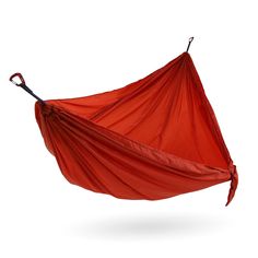 a red hammock hanging in the air with an orange cloth covering it's body