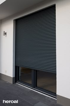 an open roller up door on the side of a building