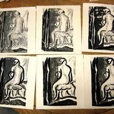 six black and white prints sitting on top of a wooden table next to a pair of scissors