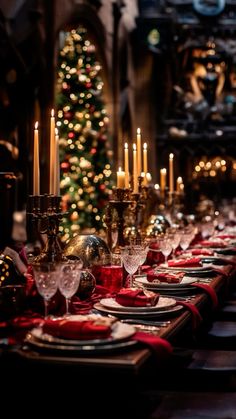 a long table is set with red and gold place settings for christmas dinner guests to enjoy