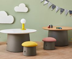 the children's furniture is arranged in different colors and sizes, including one table with two stools