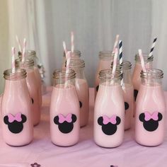 there are many mason jars with minnie mouse straws in them