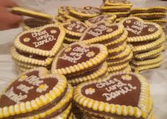 many heart shaped cookies are arranged on a table