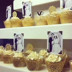 wedding cupcakes are displayed in front of pictures on the shelves at a store