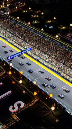 an aerial view of a race track at night