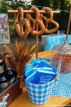 a table with beer and pretzels on it for an outdoor party or gathering