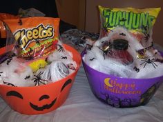 two halloween buckets filled with candy and candies