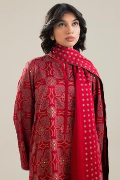 TOP:- Silk CharmeuseBOTTOM:- RawsikDUPATTA:- Silk CharmeuseOur scarlet silk shirt features a geometrical block print pattern with mukesh details. It is styled with a heavily worked mukesh lower and a dupatta with a unique polka dot border in block print. Disclaimer: Minor variations in these ensembles are intrinsic to the process of creating handcrafted products and add to their appeal. Printed Silk Kurta For Festive Occasions, Festive Silk Tops With Printed Motifs, Silk Workwear Sets With Printed Motifs, Silk Sets With Printed Motifs For Workwear, Designer Long Sleeve Sets With Dupatta, Straight Kurta With Printed Motifs For Work, Festive Printed Silk Kurta, Straight Kurta Sets With Printed Motifs For Work, Designer Long Sleeve Kurta For Work