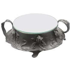 an ornately decorated glass and metal bowl