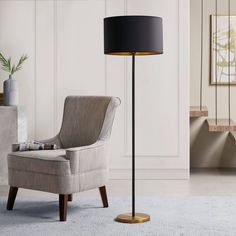 a living room with a chair and lamp in it