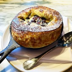 a baked pastry on a plate with spoons