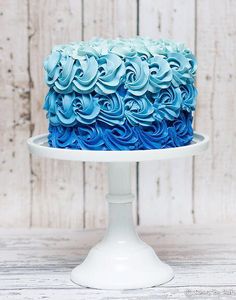 a cake with blue frosting on a white plate