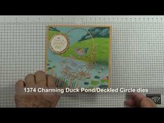 a person holding up a card with an image of a duck in the pond on it