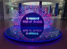 a sign that says mall of araba in front of a building with neon lights